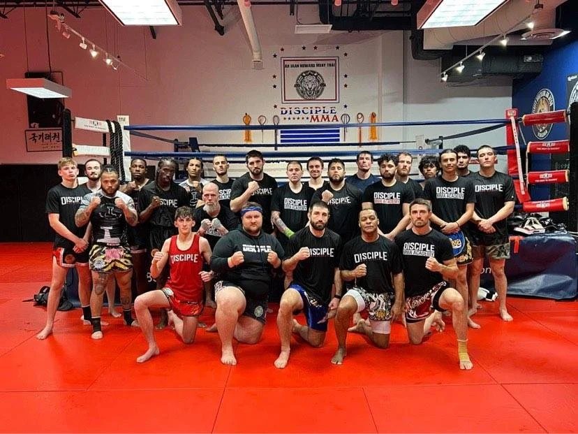 The Disciple MMA Academy team gathered in front of the ring after training